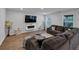 Inviting living room featuring a comfortable sofa and a contemporary electric fireplace at 201 Kingfisher Walk, Covington, GA 30014