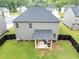 Rear exterior view showcases a covered patio and well-maintained lawn, great for outdoor entertaining at 201 Kingfisher Walk, Covington, GA 30014
