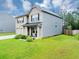 Two-story home showcasing a brick front and siding on the side, plus a lovely yard at 201 Kingfisher Walk, Covington, GA 30014