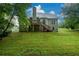 Backyard with large grassy area and landscaped yard with an exterior view of the home at 2430 Harbin Springs Cv, Dacula, GA 30019