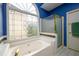 Bathroom showcasing a garden tub, glass shower, and decorative windows at 2430 Harbin Springs Cv, Dacula, GA 30019