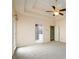 Spacious primary bedroom featuring tray ceilings, fan, and en-suite bath at 2430 Harbin Springs Cv, Dacula, GA 30019