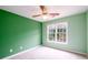 Bright bedroom with window, ceiling fan, and neutral carpet at 2430 Harbin Springs Cv, Dacula, GA 30019