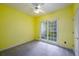 Sunny bedroom featuring wall to wall carpet and a bright yellow paint at 2430 Harbin Springs Cv, Dacula, GA 30019