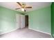 Spacious bedroom with carpet, ceiling fan, and double door closet at 2430 Harbin Springs Cv, Dacula, GA 30019