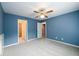 Bedroom featuring a ceiling fan, neutral carpet, and convenient access to bathroom at 2430 Harbin Springs Cv, Dacula, GA 30019