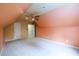 Sloped ceiling bedroom featuring ceiling fan, carpet, and a nearby closet at 2430 Harbin Springs Cv, Dacula, GA 30019