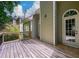 Wooden deck overlooking the backyard with an arched window and doorway at 2430 Harbin Springs Cv, Dacula, GA 30019