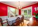 Bright dining room featuring a large window, hardwood floors, and elegant table setting at 2430 Harbin Springs Cv, Dacula, GA 30019