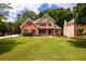 Beautiful two-story home with lush green lawn and well-maintained landscaping at 2430 Harbin Springs Cv, Dacula, GA 30019