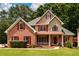 Charming brick home with manicured lawn, red shutters, and inviting front porch at 2430 Harbin Springs Cv, Dacula, GA 30019