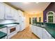 Cozy kitchen featuring white cabinetry, green countertops, and stainless-steel appliances at 2430 Harbin Springs Cv, Dacula, GA 30019