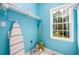Bright laundry room with painted blue walls and large window at 2430 Harbin Springs Cv, Dacula, GA 30019