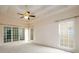 Main bedroom with tray ceilings, fan, and lots of windows at 2430 Harbin Springs Cv, Dacula, GA 30019