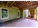 Covered patio space, with door and window, offers outdoor living with protection from the elements at 2430 Harbin Springs Cv, Dacula, GA 30019