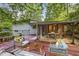 This backyard features a wraparound deck with outdoor seating surrounded by trees and greenery at 3539 Eaglerock Dr, Doraville, GA 30340