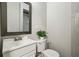 Small, clean bathroom features a white vanity and toilet, with a view into the mirror at 3539 Eaglerock Dr, Doraville, GA 30340