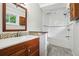 Bright bathroom featuring a combined tub and shower with updated fixtures and a wood vanity at 3539 Eaglerock Dr, Doraville, GA 30340