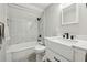 This bathroom features a shower and tub, white marbled tile walls, and a matching vanity at 3539 Eaglerock Dr, Doraville, GA 30340