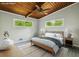 Calm bedroom with natural light, neutral decor, wood ceiling, and hardwood floors at 3539 Eaglerock Dr, Doraville, GA 30340