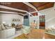 Bright living room with wood floors, high ceilings, fireplace, and view into updated kitchen at 3539 Eaglerock Dr, Doraville, GA 30340