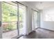 Bright living area featuring access to a balcony with sliding glass doors, wood flooring, and natural light, creating a relaxing space at 399 Pratt Se Dr # 910, Atlanta, GA 30315