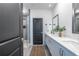 Stylish bathroom featuring double sinks, a walk-in shower with glass door, and modern fixtures at 399 Pratt Se Dr # 910, Atlanta, GA 30315