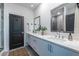 Modern bathroom featuring double sinks with white countertops and a decorative vase with greenery at 399 Pratt Se Dr # 910, Atlanta, GA 30315