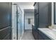 Clean bathroom with blue cabinets, double sinks, glass shower, and modern fixtures, creating a functional and stylish space at 399 Pratt Se Dr # 910, Atlanta, GA 30315