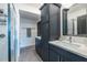 Modern bathroom featuring sleek blue cabinets, double sinks, a glass-enclosed shower, and updated fixtures for a clean, stylish design at 399 Pratt Se Dr # 910, Atlanta, GA 30315