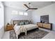 Bright bedroom with a large bed, ceiling fan, a patterned area rug, and three windows for natural light at 399 Pratt Se Dr # 910, Atlanta, GA 30315