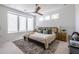 Bright bedroom featuring a large bed, ceiling fan, neutral colors, an area rug, and large windows at 399 Pratt Se Dr # 910, Atlanta, GA 30315