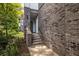 Brick exterior and stairway leads to a modern townhome entrance, providing curb appeal at 399 Pratt Se Dr # 910, Atlanta, GA 30315