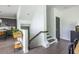 Bright entryway features wood floors, modern railing and access to the kitchen with stainless appliances at 399 Pratt Se Dr # 910, Atlanta, GA 30315