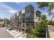 Modern townhome with balconies, garages, manicured landscaping and on-site parking, creating an inviting atmosphere at 399 Pratt Se Dr # 910, Atlanta, GA 30315