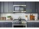 Close up of kitchen with stainless steel stove top, oven, and subway tile backsplash at 399 Pratt Se Dr # 910, Atlanta, GA 30315