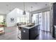 Open kitchen and living area featuring a large island, stainless appliances, and hardwood flooring at 399 Pratt Se Dr # 910, Atlanta, GA 30315