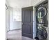 Efficient laundry area with a gray stackable washer and dryer, seamlessly integrated with a door to maximize space at 399 Pratt Se Dr # 910, Atlanta, GA 30315