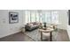 Cozy living room with modern rug, decor, gray sofa, and lots of light for relaxed comfort at 399 Pratt Se Dr # 910, Atlanta, GA 30315