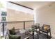 Cozy patio features a seating area with black metal furniture, neutral colored rug, and a retractable awning at 399 Pratt Se Dr # 910, Atlanta, GA 30315