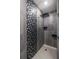 Modern shower featuring gray tile with mosaic accents, a rainfall shower head, and built in shelving at 399 Pratt Se Dr # 910, Atlanta, GA 30315