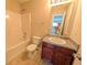 Traditional bathroom with shower-tub combo, white porcelain toilet, and vanity with dark wood cabinets at 5622 Platte Dr, Ellenwood, GA 30294