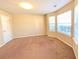 Bright, carpeted bedroom with three windows offering ample natural light and neutral tones at 5622 Platte Dr, Ellenwood, GA 30294
