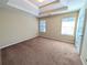 Bedroom with tray ceiling, neutral carpet, and natural light coming from the windows at 5622 Platte Dr, Ellenwood, GA 30294