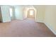 Bedroom featuring tan walls, a large window, and beige carpet at 5622 Platte Dr, Ellenwood, GA 30294