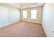 Bright bedroom features two windows, plush carpeting, neutral colored walls and white trim at 5622 Platte Dr, Ellenwood, GA 30294