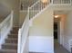 Inviting foyer with staircase, white railings, and view into adjacent room at 5622 Platte Dr, Ellenwood, GA 30294