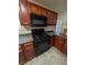 Close up of kitchen featuring stainless steel appliances, tile flooring, and wood cabinets at 5622 Platte Dr, Ellenwood, GA 30294