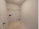 Small laundry room with a white wire shelf and tiled floor at 5622 Platte Dr, Ellenwood, GA 30294