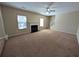 Spacious living room features fireplace, ceiling fan, and access to an adjacent staircase at 5622 Platte Dr, Ellenwood, GA 30294